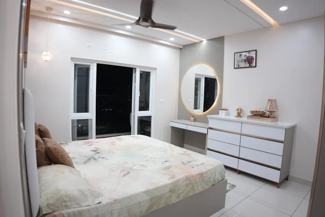 Bedroom with dresser unit and round backlit mirror