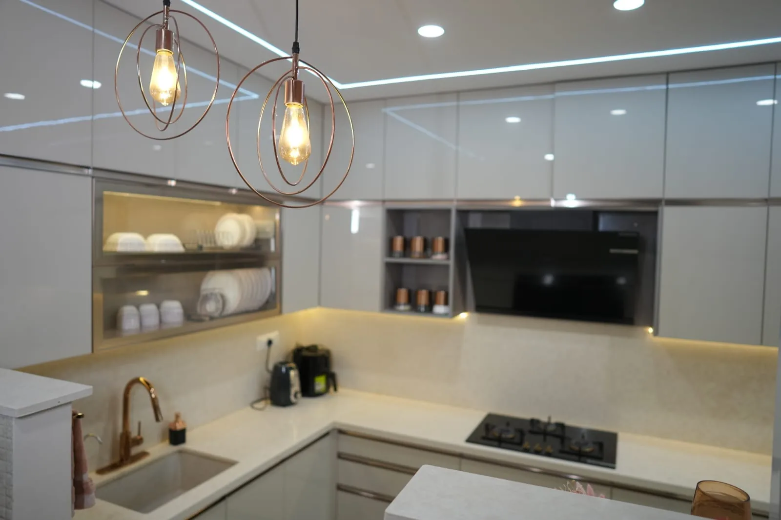 Kitchen with globe pendants and integrated appliances