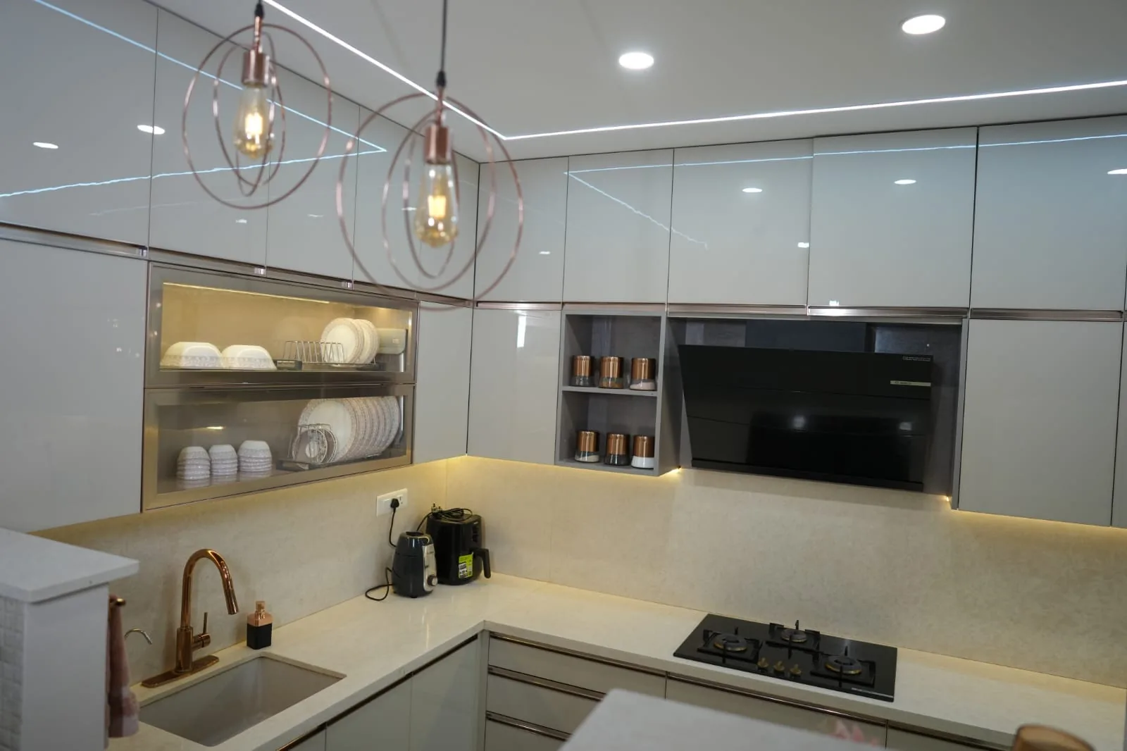 Kitchen with glass pendant lights and open crockery shelving