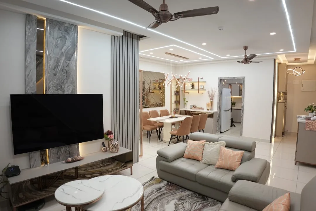 Living and dining with marble TV wall and cove lighting
