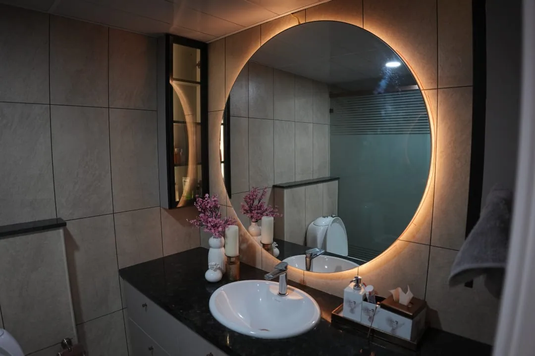 Bathroom vanity with round backlit mirror